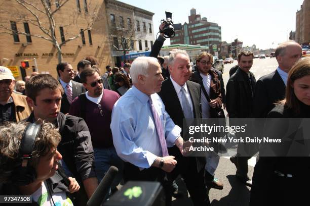 Presidential hopeful John McCain walks with the media in tow from Windows We Are Inc. To Verrazano Pizza during a campaign stop in Bay Ridge Brooklyn.