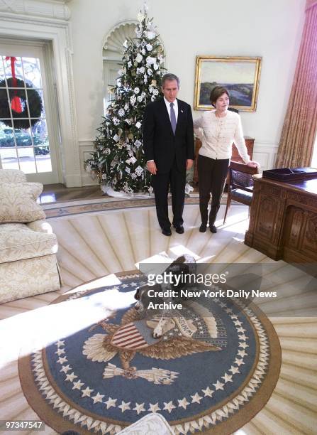 Presidential pooch Spot, an English springer spaniel, trots across a new carpet on the floor of the White House's Oval Office in search of a good...