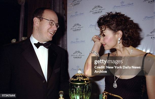 Prince Albert of Monaco watches as Ashley Judd samples the scent at the Waldorf-Astoria where they unveiled the Grace de Monaco Parfum Collection by...