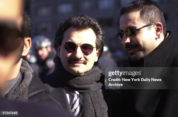 Prince Alwaleed bin Talal bin Abdulaziz Al Saud of Saudi Arabia , with a bodyguard by his side, watches a demonstration against the World Economic...