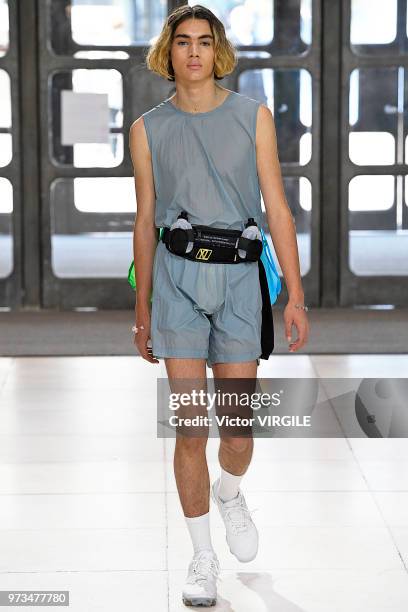 Model walks the runway at the Xander Zhou Spring/Summer 2019 fashion show during London Fashion Week Men's June 2018 on June 10, 2018 in London,...