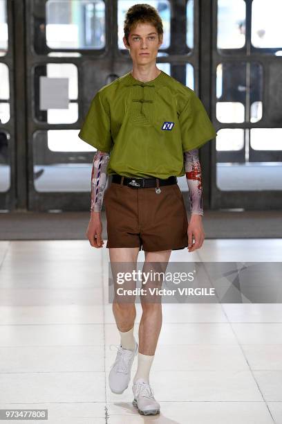 Model walks the runway at the Xander Zhou Spring/Summer 2019 fashion show during London Fashion Week Men's June 2018 on June 10, 2018 in London,...