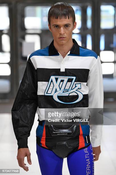 Model walks the runway at the Xander Zhou Spring/Summer 2019 fashion show during London Fashion Week Men's June 2018 on June 10, 2018 in London,...