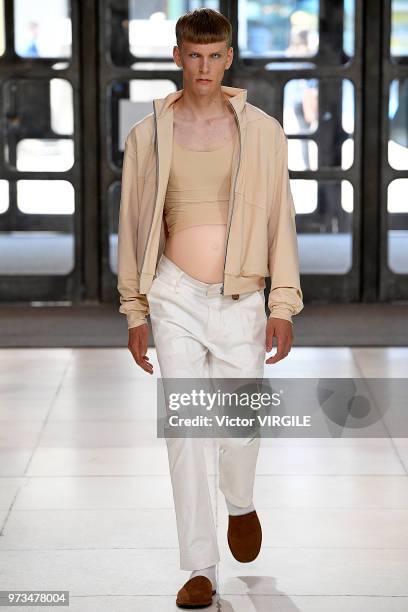 Model walks the runway at the Xander Zhou Spring/Summer 2019 fashion show during London Fashion Week Men's June 2018 on June 10, 2018 in London,...