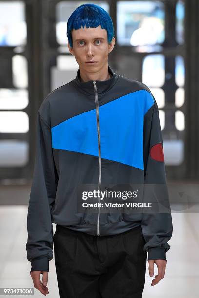 Model walks the runway at the Xander Zhou Spring/Summer 2019 fashion show during London Fashion Week Men's June 2018 on June 10, 2018 in London,...