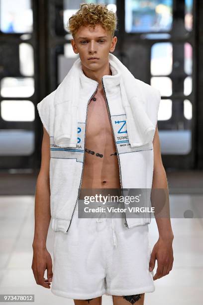 Model walks the runway at the Xander Zhou Spring/Summer 2019 fashion show during London Fashion Week Men's June 2018 on June 10, 2018 in London,...