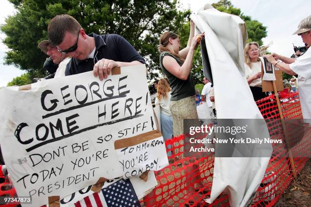 Protesters tear down their signs outside the Woodside Hospice in Pinellas Park, Fla., where Terri Schiavo died this morning, 13 days after her...