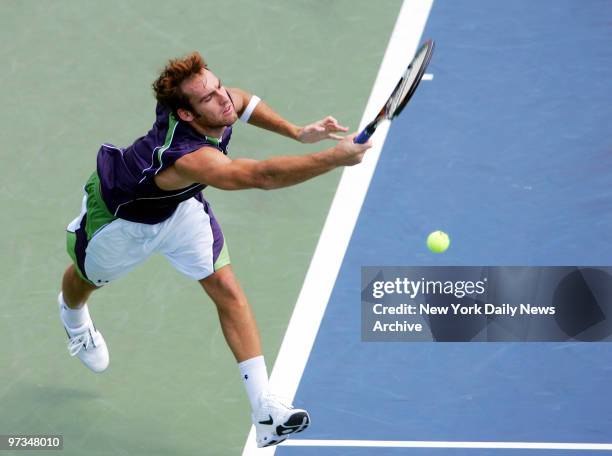 Robby Ginepri of the U.S. Returns the ball to Tommy Haas of Germany during the third round of the U.S. Open Men's Singles competition in Louis...