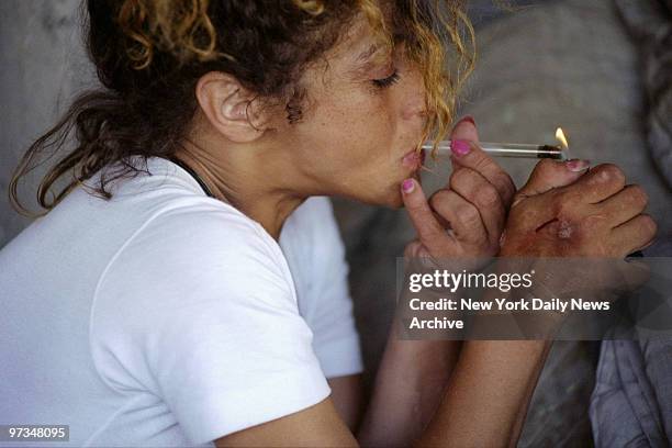 Prostitute Gloria Colon smokes crack after shooting up heroin, which helps her to function.,