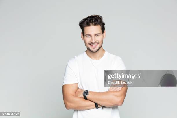 young man standing confidently - smiling man with beard stock pictures, royalty-free photos & images