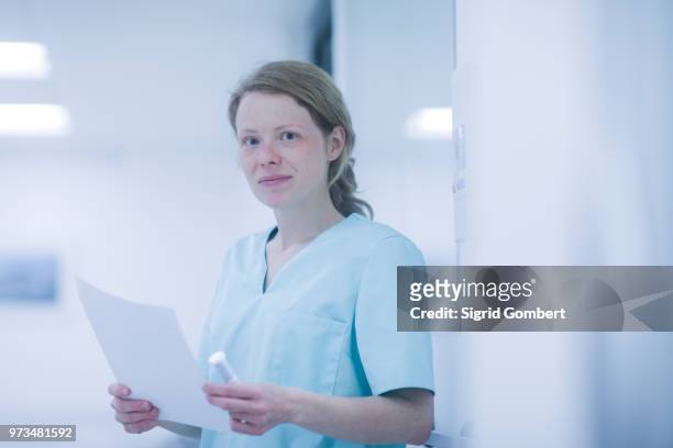 portrait of radiologist, holding document - sigrid gombert stock pictures, royalty-free photos & images