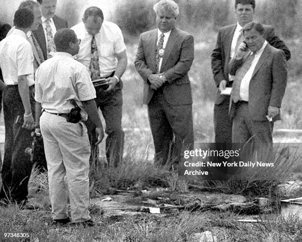 Queens District Attorney Richard Brown leads team of detectives at scene of remains of the serial killer Joel Rifkin near JFK airport.