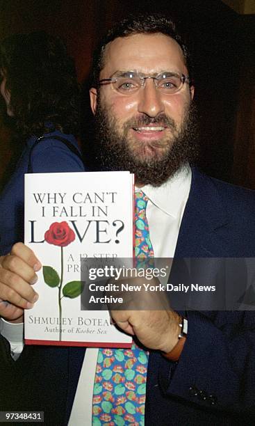Rabbi Shmuley Boteach holds a copy of his book, "Why Can't I Fall in Love," at a party at Prime Grill on E. 49th St.