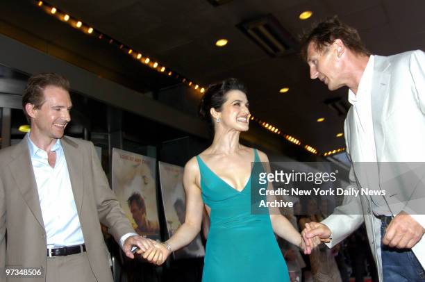 Rachel Weisz keeps a firm grip on fellow actors Ralph Fiennes and Liam Neeson during the New York premiere of "The Constant Gardener" at Loews...