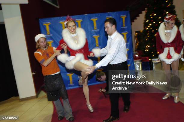 Radio City Music Hall Rockette Kandice Pelletier stands by as workers move her wax figure at Madame Tussaud's Wax Museum in Times Square.