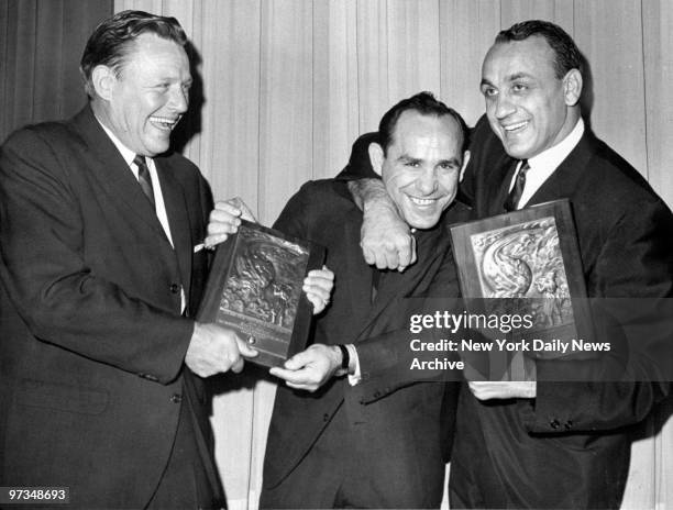 Ralph Houk and Andy Robustelli gang up on Yogi Berra at the New York Press Photographers Sports Awards dinner at the Lambs Club.They were honored as...