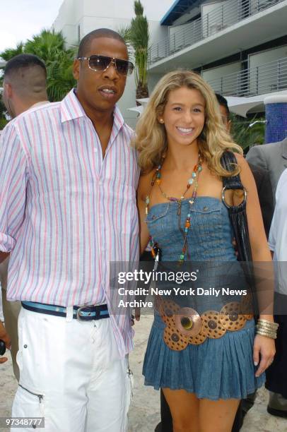 Rap mogul Jay-Z gets together with singer-songwriter Ana Cristina by the pool at the Ritz-Carlton, South Beach hotel in Miami Beach, Fla., during a...