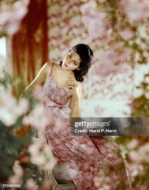 Model wearing cloud-printed nightdress in rosy pink opaque nylon with slim pink velvet shoulder straps; velvet waist tie and Empire band. By Vanity...