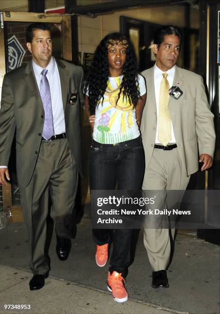 Rapper Remy Ma is escorted out of the sixth Precinct stationhouse after being questioned in the shooting of her close friend Makeda Barnes-Joseph, in...