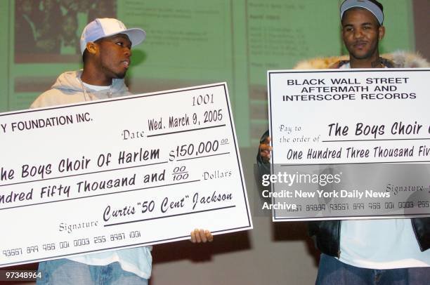 Rappers 50 Cent and The Game share the stage during a news conference at the Schomburg Center for Research in Black Culture in Harlem, where they...