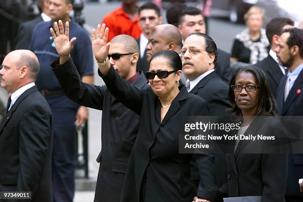 Rashad and Diane Haughton, Aaliyah's brother and mother, salute crowd of mourning fans as they arrive at St. Ignatius Loyola Roman Catholic Church on...