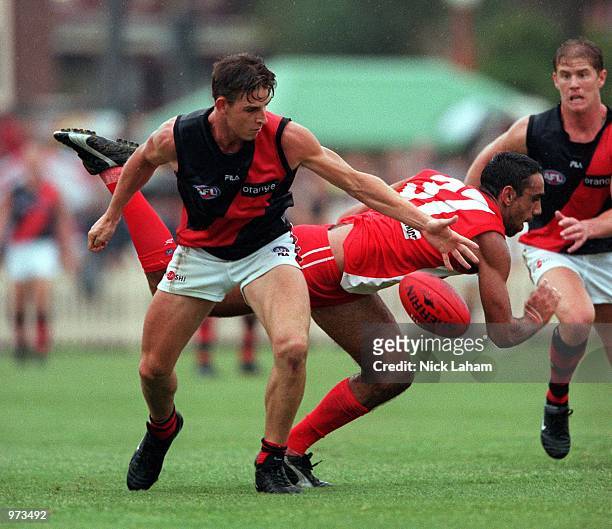 Danny Jacobs of Essendon Bombers competes for the ball with Adam Goodes of Sydney Swans during the AFL trial game played at North Sydney Oval,...