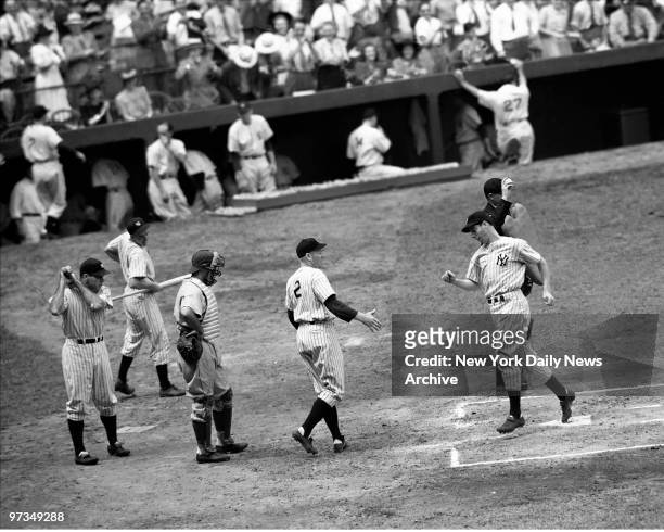Red Rolfe greets Joe DiMaggio after Yankee Clipper belts home run against the Philadelphia A's to extend The Streak to 46 straight at Yankee Stadium.