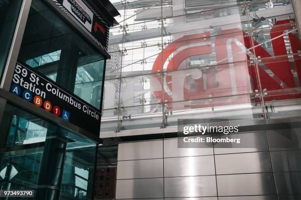 Subway entrance stands in front of a building complex displaying Time Warner Inc. Brand CNN television network signage in New York, U.S., on...