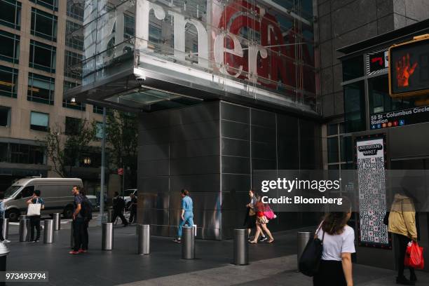 Pedestrians pass in front of the Time Warner Center in New York, U.S., on Wednesday, June 13, 2018. AT&T Inc.'s sweeping court victory allowing its...