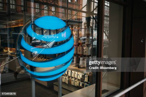 The AT&T Inc. Logo is displayed outside a store in New York, U.S., on Wednesday, June 13, 2018. AT&T Inc.'s sweeping court victory allowing its...