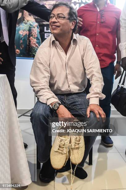 Presidential candidate Gustavo Petro, from Colombia Humana Movement, holds a pair of shoes during a political rally ahead of the runoff election, in...