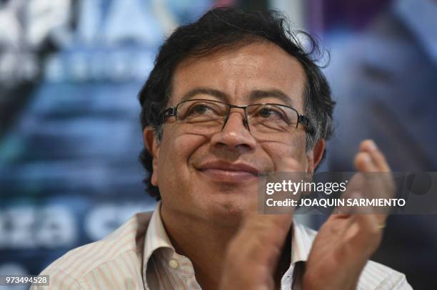 Presidential candidate Gustavo Petro, from Colombia Humana Movement, applauds during a political rally ahead of the runoff election, in Medellin,...