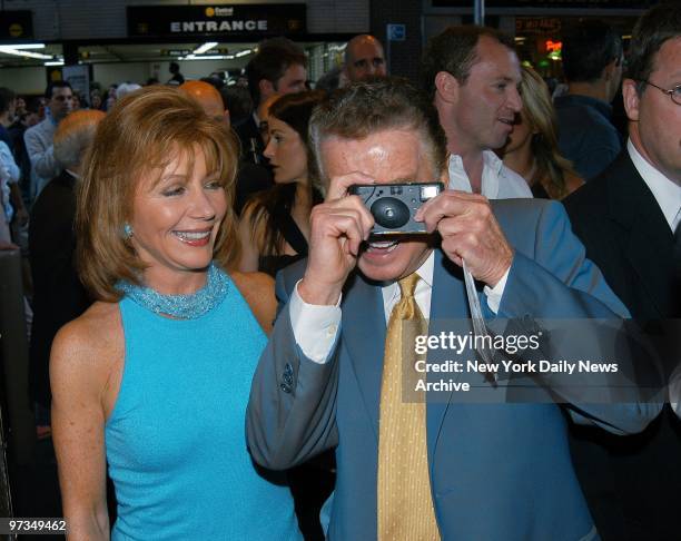 Regis Philbin turns his camera at photographers as he and wife Joy arrive at the Belasco Theatre for the opening of the Broadway play "Frankie and...
