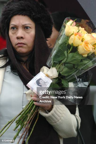Relative of Balbina Soto De Rodriguez, who was killed in the crash of American Airlines Flight 587, glares at a new house built at the crash site at...