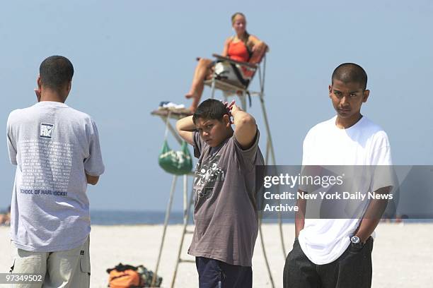 Relatives wait at Beach 17th St. In Far Rockaway, Queens, for word of two of the three young girls who drowned when they were swept out to sea by a...