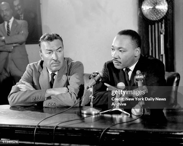 Rep. Adam Clayton Powell and Dr. Martin Luther King talk to press at Abyssinian Baptist Church.