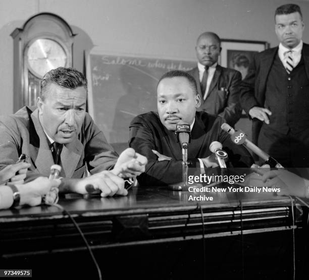 Rep. Adam Clayton Powell and Dr. Martin Luther King talk to press at Abyssinian Baptist Church.
