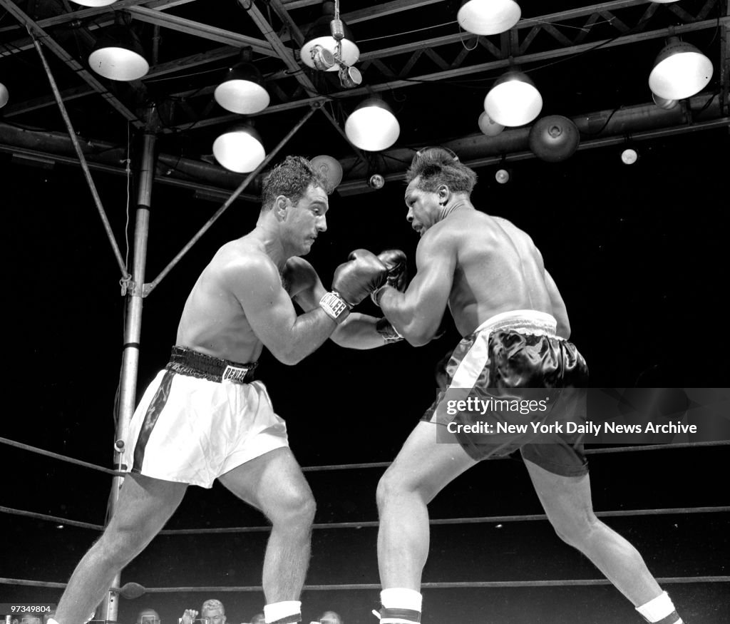 Rocky Marciano and Archie Moore lunge at each other but no d