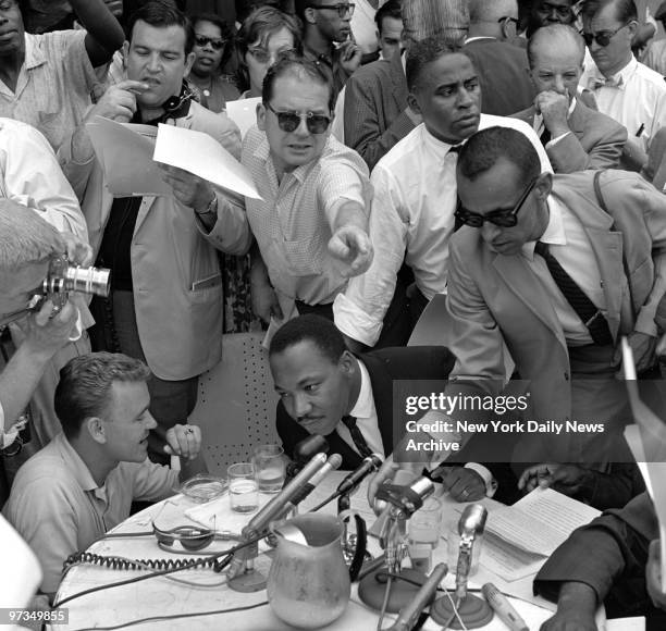 Reporters reach for statement as the Rev. Martin Luther King announces agreement in Birmingham.