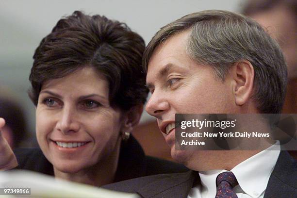 Reps. Mary Bono and Lindsey Graham confer during a House Judiciary committee hearing on the possible impeachment of President Clinton.