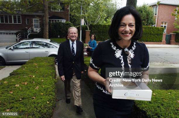 Republican Senate candidate Kathleen McFarland, who carries an apple pie, and former National Security Adviser Robert McFarlane visit the home of a...