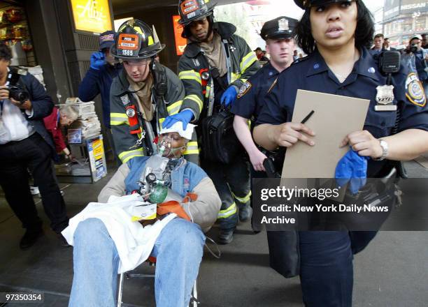 Rescue workers remove an injured passenger from Penn Station to an ambulance. He was hurt when a virtually empty Amtrak train rear-ended a Long...