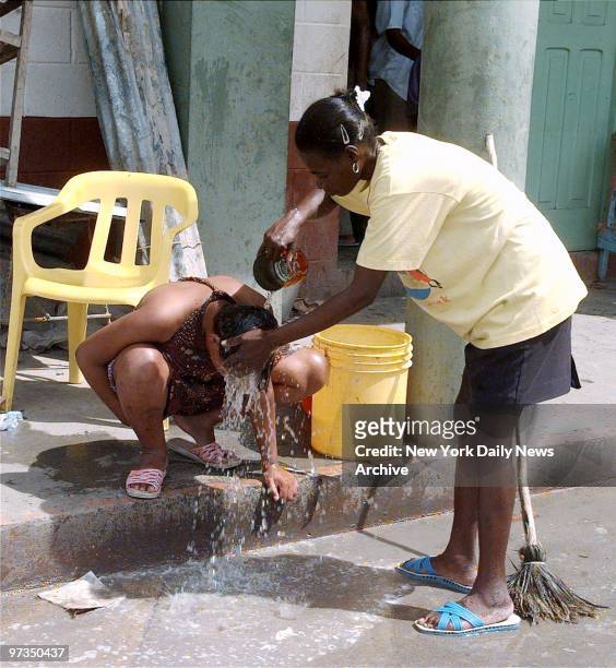 Residents use makeshift bath after Hurricane Georges in Santo Domingo.