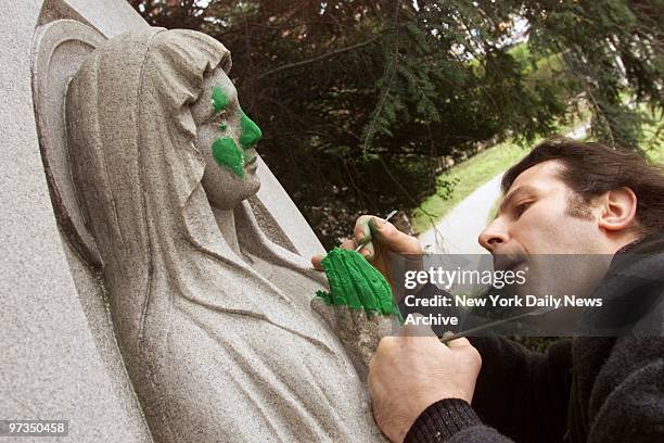 Restorer works to repair damaged staute of the Virgin Mary outside Holy Cross Church on Church Ave. Newly-created Council on Human Rights is raising...