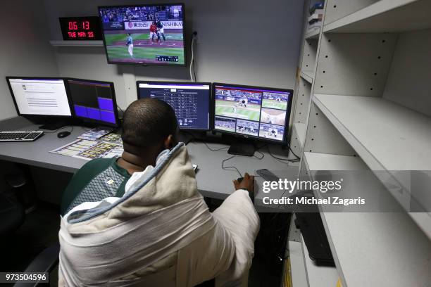 Santiago Casilla of the Oakland Athletics studies video in the clubhouse prior to the game against the Seattle Mariners at the Oakland Alameda...