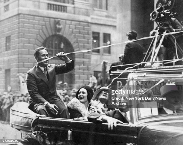 Returning with British Open and amateur golf championships, Bobby Jones receives huge New York welcome. This ticker tape streamer ensnared him as he...
