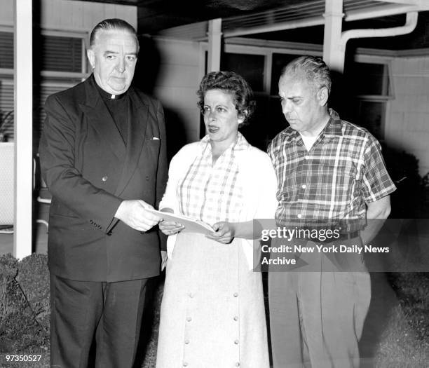 Rev. Thomas F. Code, Pastor of St. Brigids Church in Westbury, representing the Clergy of All Faiths gets appeal from Morris and Beatrice Weinberger,...