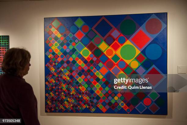 Visitor looks at the painting 'Marsan-2' during the press opening of the retrospective exhibition of Victor Vasarely named ‘The Birth of Op Art’....