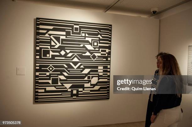 Two visitors look at an artwork during the press opening of the retrospective exhibition of Victor Vasarely named ‘The Birth of Op Art’. Held in the...