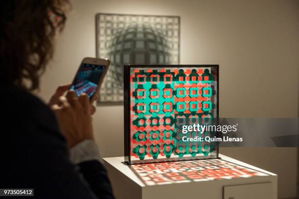 Visitor takes a photo to the multiple 'Helios' during the press opening of the retrospective exhibition of Victor Vasarely named ‘The Birth of Op...
